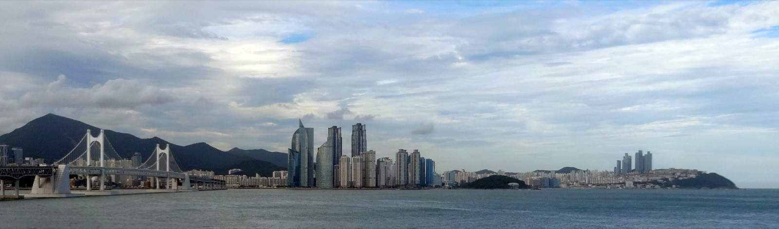 The Haeundae skyline from Igidae, towers rising between the mountains and the sea